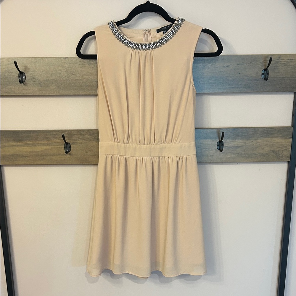 Elegant Cream Sleeveless Dress with Embellished Neckline